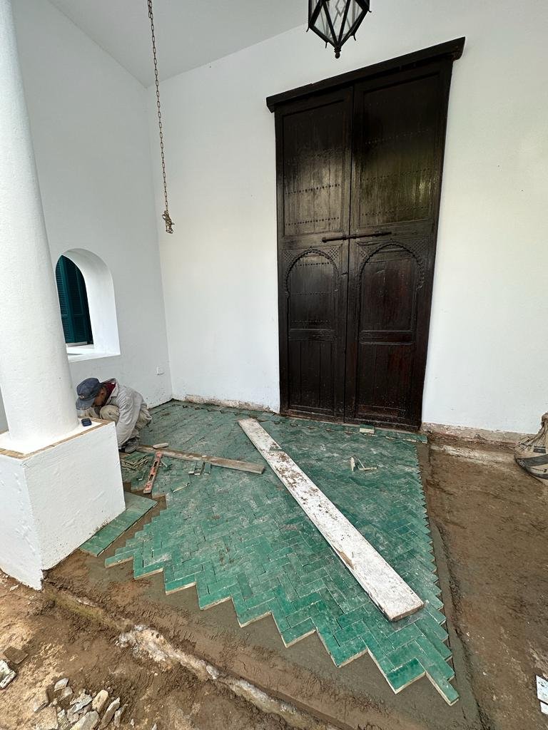 Herringbone floor being laid during installation