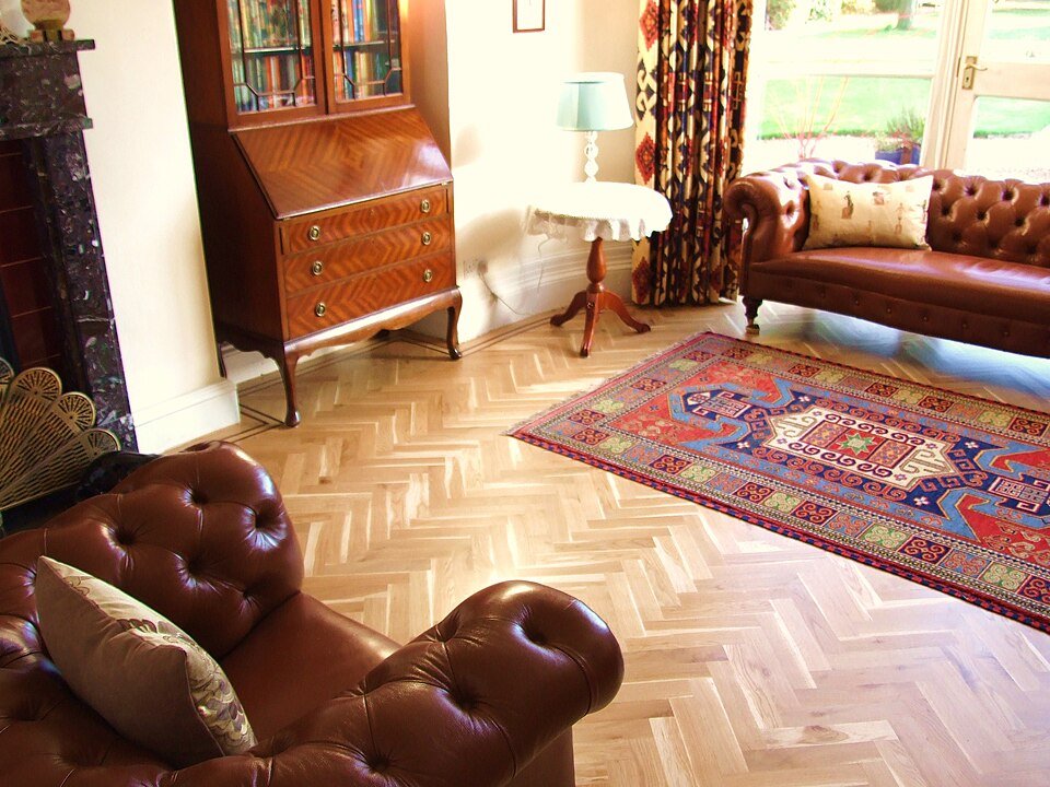 Oak herringbone wood floor with dark border