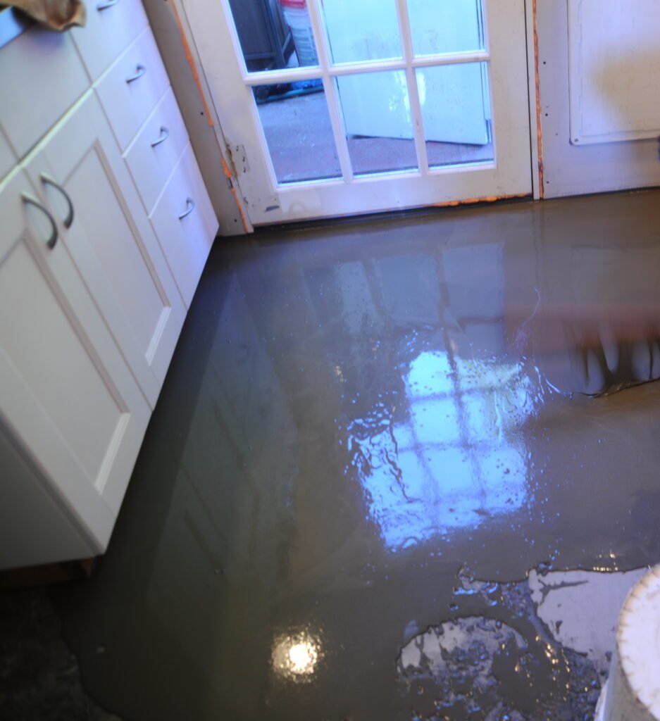 Self-levelling compound being poured on a subfloor before tiling