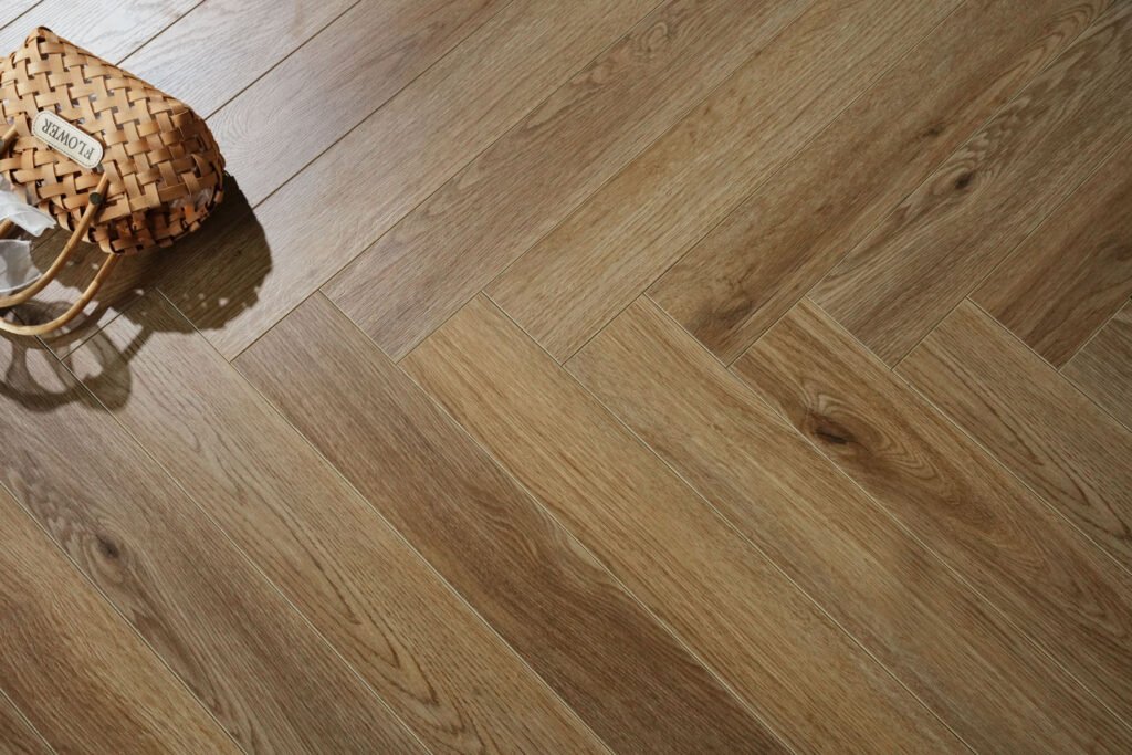 Milan Honey Oak herringbone laminate flooring captures the golden warmth and timeless charm of sun-kissed oak, with a lightly textured wood-grain