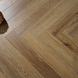 Milan Honey Oak herringbone laminate flooring captures the golden warmth and timeless charm of sun-kissed oak, with a lightly textured wood-grain
