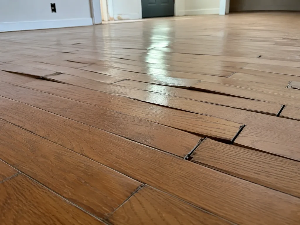 Cupped and gapped wood floor caused by skipping acclimatisation and moisture control.